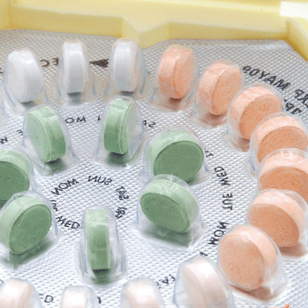 close up on a woman's birth control pill kit